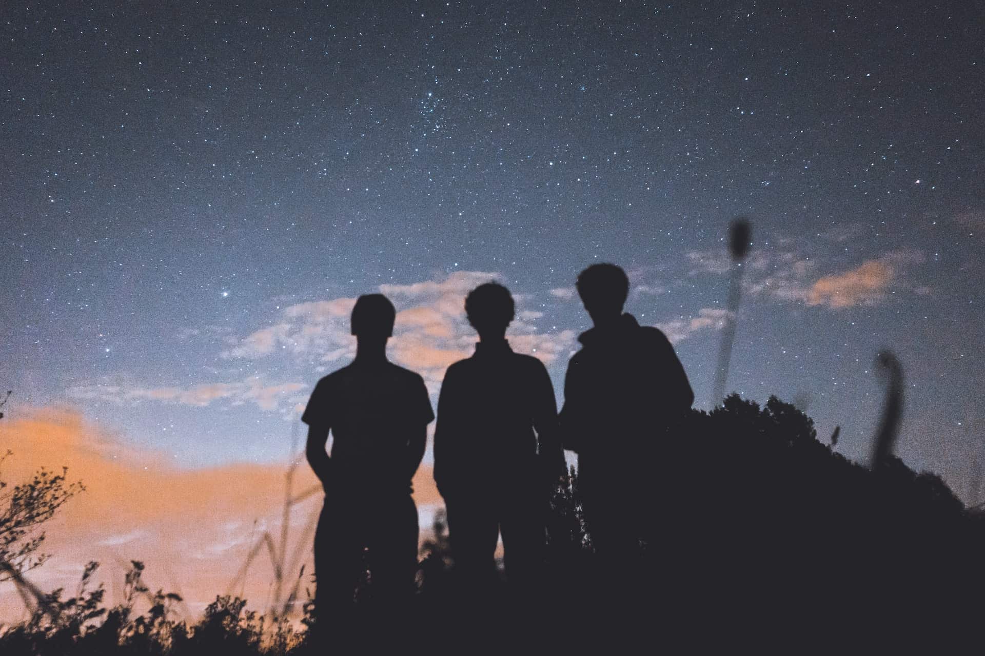 Silhouettes of three men standing under a starry sky Silhouettes of three men standing under a starry sky.