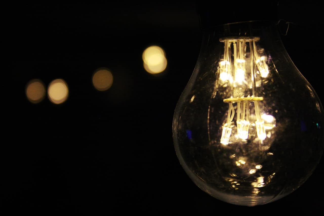 A light bulb is lit up in the dark A light bulb is lit up in the dark.